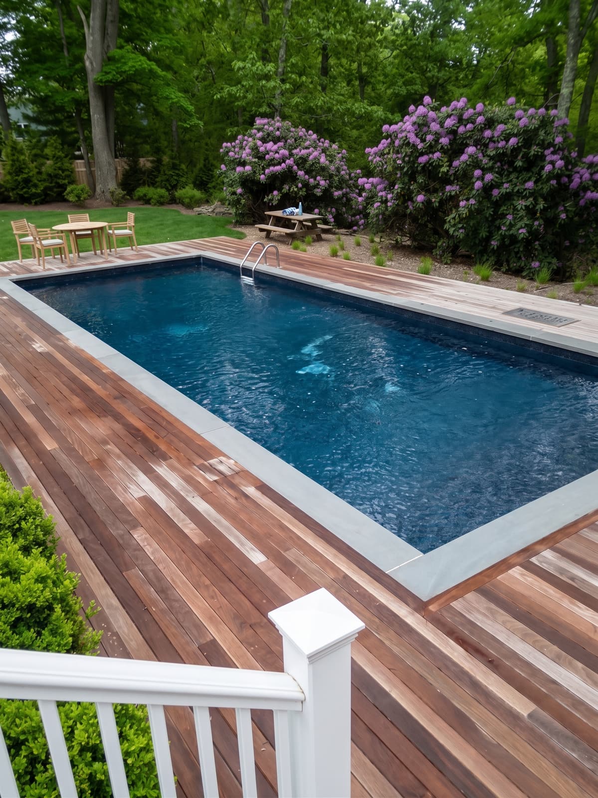 Custom pool surrounded by an ipe hardwood deck and manicured plantings