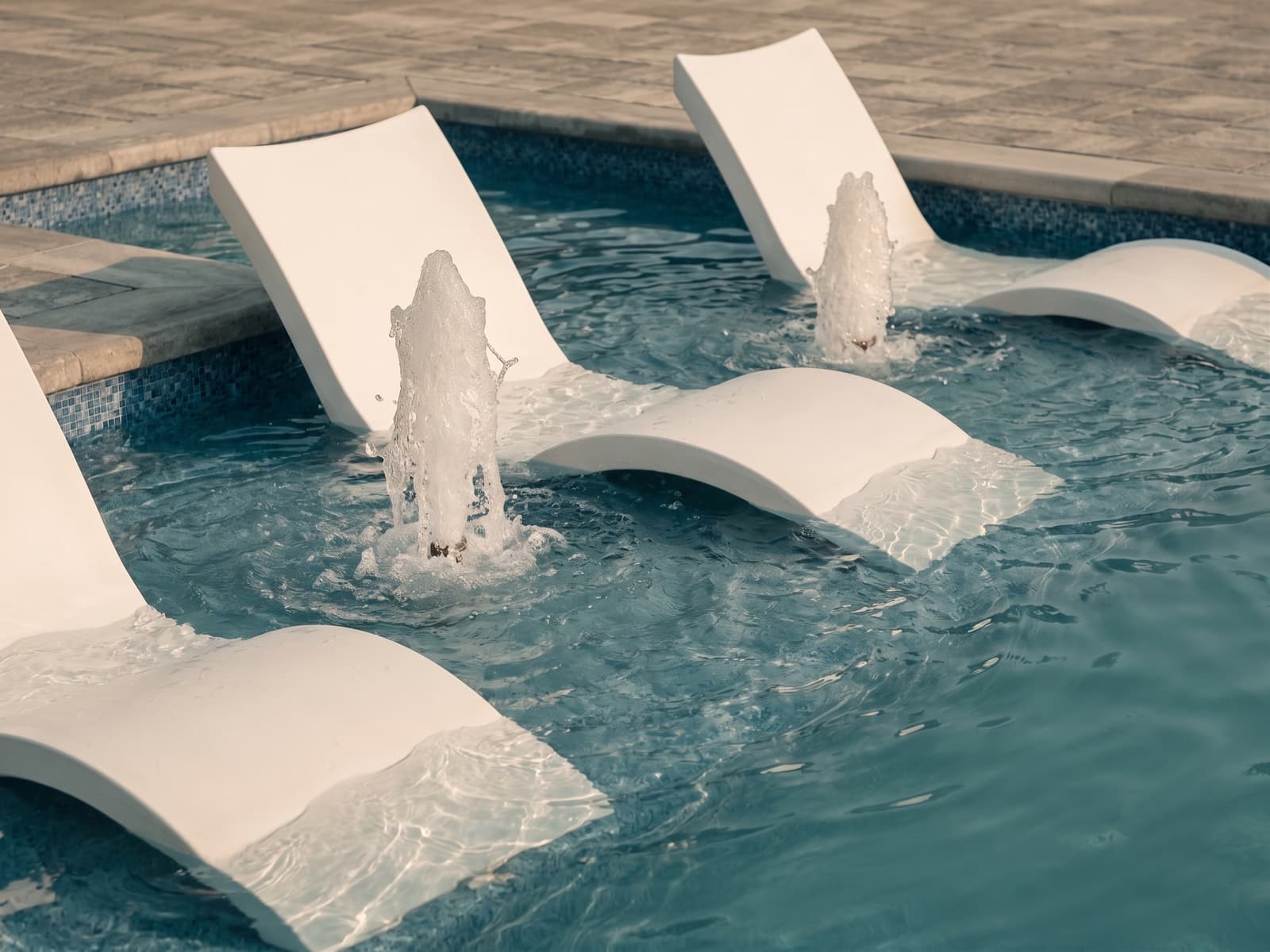 Close-up of bubbler jets on a sun-shelf tanning ledge
